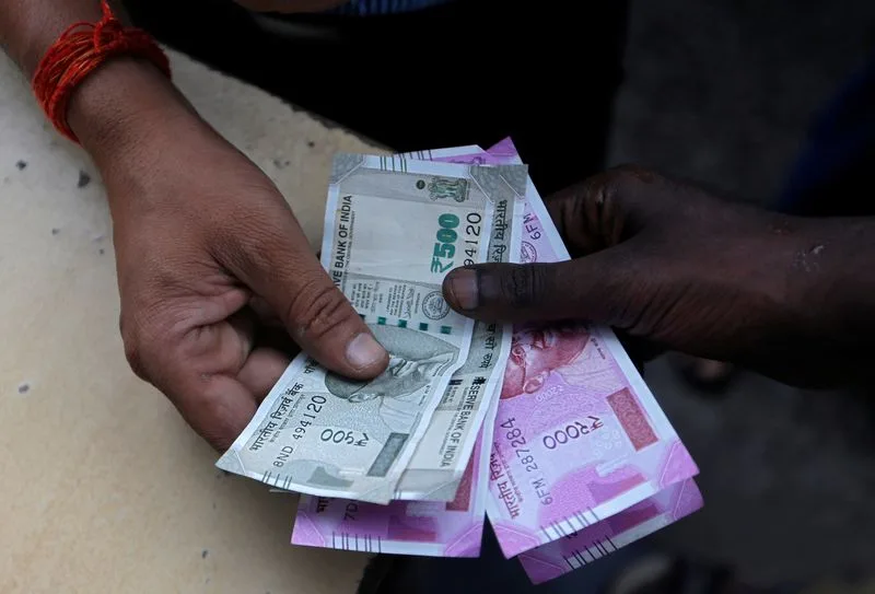 Rupee settles at record closing low as equity tax hikes hurt sentiment